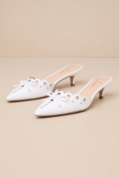 You'll be obsessed with styling the Lulus Cerine White Studded Pointed-Toe Mule Pumps with your most favorite spring ensembles! Smooth faux leather shapes these trendy pumps that feature a classy pointed-toe upper with a scalloped, low-cut collar. Embellishments like silver grommets and studded accents (of varying sizes) lend an edgy essence to this slide-on design. An iconic kitten-style heel makes for comfortable all-day wear, while a dainty bow detail creates the perfectly chic finish! 2" wra Collar Embellishments, Trendy Pumps, Mule Pumps, Casual Formal Dresses, White Studs, Lulu Fashion, Casual Wedding Dress, Shoes Heels Pumps, Most Favorite