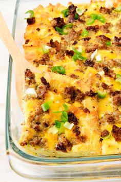 a casserole dish with sausage, onions and green peppers in a glass baking dish