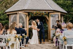 a bride and groom standing at the end of their wedding ceremony