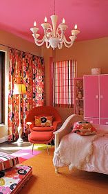 a bedroom with pink walls, orange carpet and chandelier hanging from the ceiling