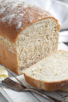 a loaf of white bread sitting on top of a cutting board