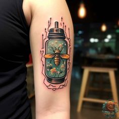 a woman's arm with a tattoo on it that has a bee in a jar