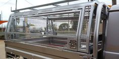 a large truck with a cage on the back of it's door and windows