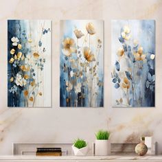 three paintings on a wall in a living room