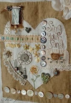 a close up of a piece of cloth with buttons on it and a clock in the shape of a heart