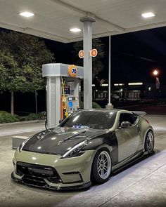 a sports car parked in front of a gas station