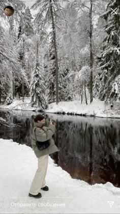 a man standing in the snow taking a photo