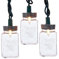 three mason jars with lights attached to them