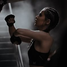 a woman in black top and boxing gloves