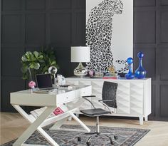 a white desk sitting in front of a black wall