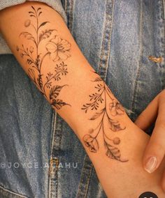 a person with a flower tattoo on their arm