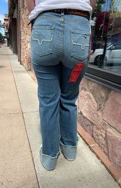 A high-rise stovepipe jean with a wide leg and raw hem, the Olivia is the perfect everyday jean. Made from tri-blend denim for maximum wearability and rebound, this lightweight jean is accented with the iconic Longhorn logo on both back pockets.Fabric: 82% Cotton | 15% Polyester | 3% ElastaineFit: High Rise, Stove Top, Wide Leg with a Raw HemDetails: Hand sanding on light wash denim with whisker detailConstruction: 11.5 Oz. DenimKimes jeans have the longevity and durability because they use sour 7s Jeans, Kimes Jeans, Kimes Ranch Jeans, Wide Leg Jeans Outfit, Artisan Jewelry Necklaces, My Shopping List, Chain Top, Graphic Tops, Jeans Outfit