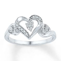 This sweet ring has diamonds embellishing a heart as its lovely centerpiece. The sterling silver ring has a total diamond weight of 1/20 carat. Heart Engagement, Heart Promise Rings, Black Gold Jewelry, Diamond Heart Ring, Silver Jewelry Rings, Rings For Her, Engagement Rings Sapphire, Diamond Heart, Unique Engagement Rings