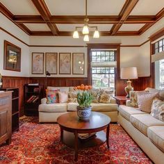 a living room filled with furniture and lots of windows