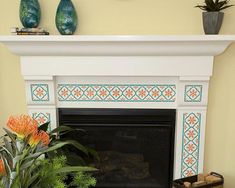 a fireplace is decorated with orange flowers and potted greenery on the mantel