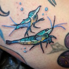 two colorful lizards on the back of a woman's stomach