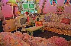 a living room filled with lots of furniture and decor in pink walls next to a window