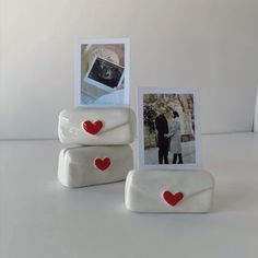 two white frames with red hearts on them