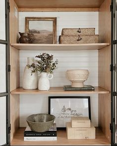 some shelves with vases and pictures on them