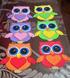 an image of colorful owls with big eyes on the back of a tablecloths