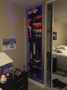 Nerf Gun Rack Backlite by LED's. Peg board, frame, LED strips(changes 16 different colors! Came out great! Boys Bedroom Decor, Peg Board, Bedroom Storage