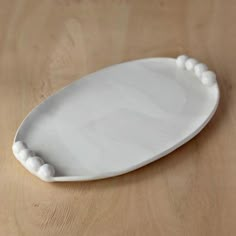 a white plate sitting on top of a wooden table