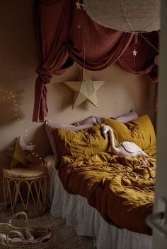 a bed room with a neatly made bed and two swans on the bed next to it