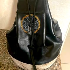 Leather Handbag With Maasai Embroidery Luxury Black Backpack For Evening, Luxury Black Evening Backpack, Evening Leather Backpack With Detachable Strap, Traditional Black Travel Bag, Luxury Embroidered Travel Bags, Traditional Black Rectangular Bag, Traditional Black Tote Shoulder Bag, Traditional Black Tote Bag, Designer Embroidered Shoulder Bag For Travel