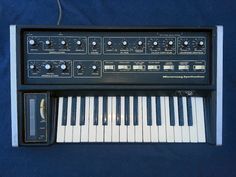 an electronic keyboard sitting on top of a blue sheet