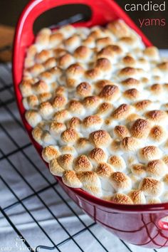 a red casserole dish filled with marshmallows on a cooling rack