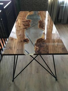 a glass table sitting on top of a wooden floor