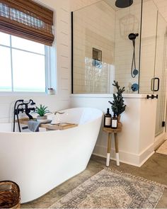 a white bath tub sitting next to a window