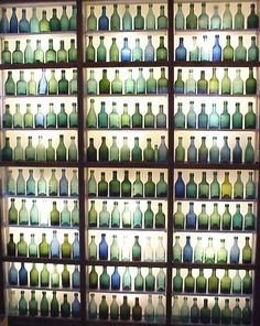 many bottles are lined up on the wall