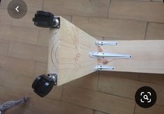 an upside down view of a skateboard with some tools attached to the back end