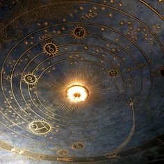 the ceiling is decorated with gold stars and zodiacs on it, as well as other astro symbols