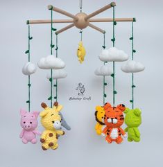 three crocheted stuffed animals hanging from a mobile