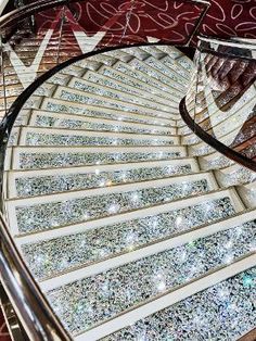 a spiral staircase with lots of diamonds on the treadmills and handrails