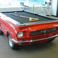 an old red car with a pool table on the front and bottom, says because these are the only balls a ford will ever have