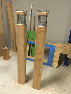 two pieces of wood sitting next to each other on top of a floor in a room