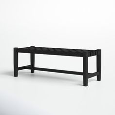 a black bench sitting on top of a white floor