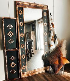 a large mirror sitting on top of a wooden floor