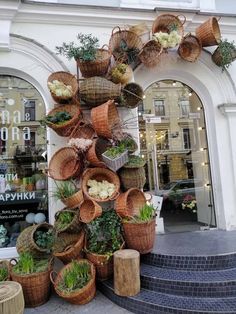 several baskets are stacked on top of each other in front of a building with stairs