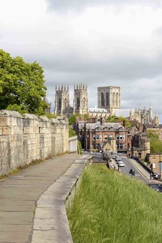 a view of the city and its cathedrals from an old bridge in york, england