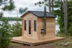 a small wooden cabin sitting next to a lake