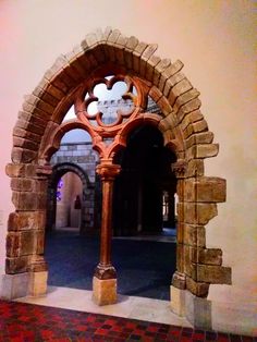 an arched doorway with a clock on it