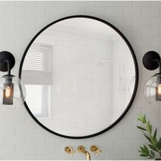 a round mirror mounted to the side of a wall next to a faucet