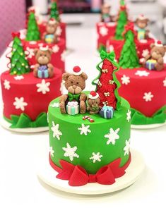 there are many small cakes decorated with teddy bears and presents on the top one is green