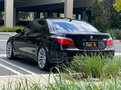 a black car parked in front of a parking garage