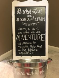 a chalkboard sign in the corner of a room next to a metal pan with writing on it