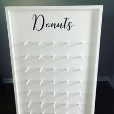 there is a sign that says donuts on the front and side of it with pins stuck to it